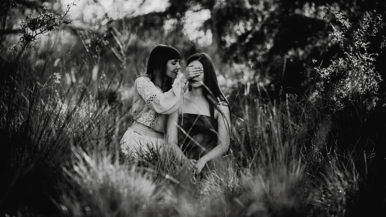 girls whispering on meadow